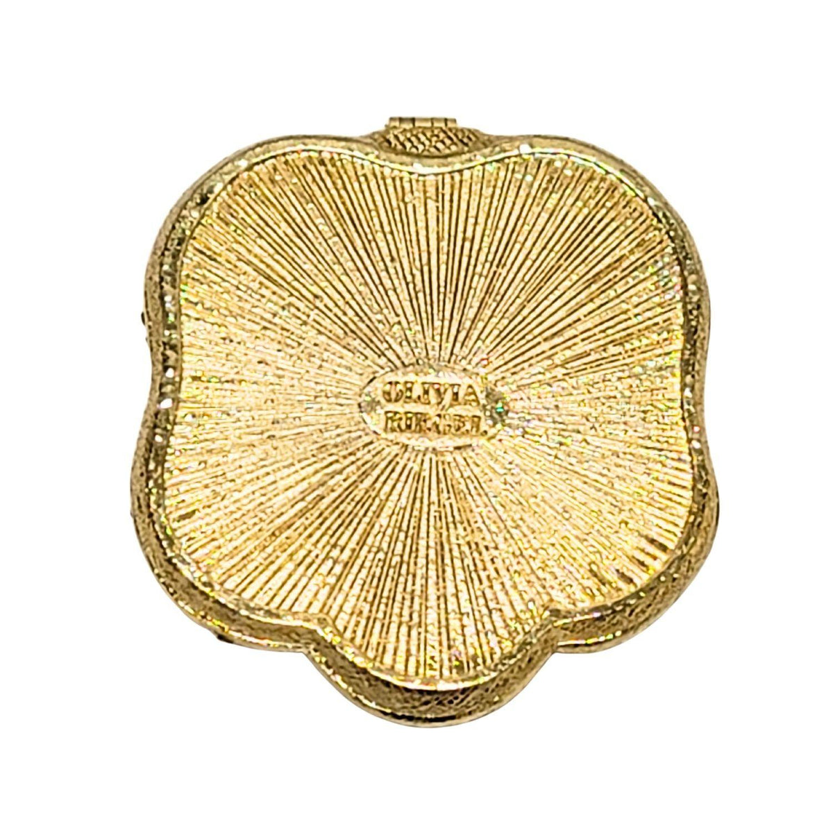 Gold textured bottom of Serpentina Compact with a scalloped silhouette.