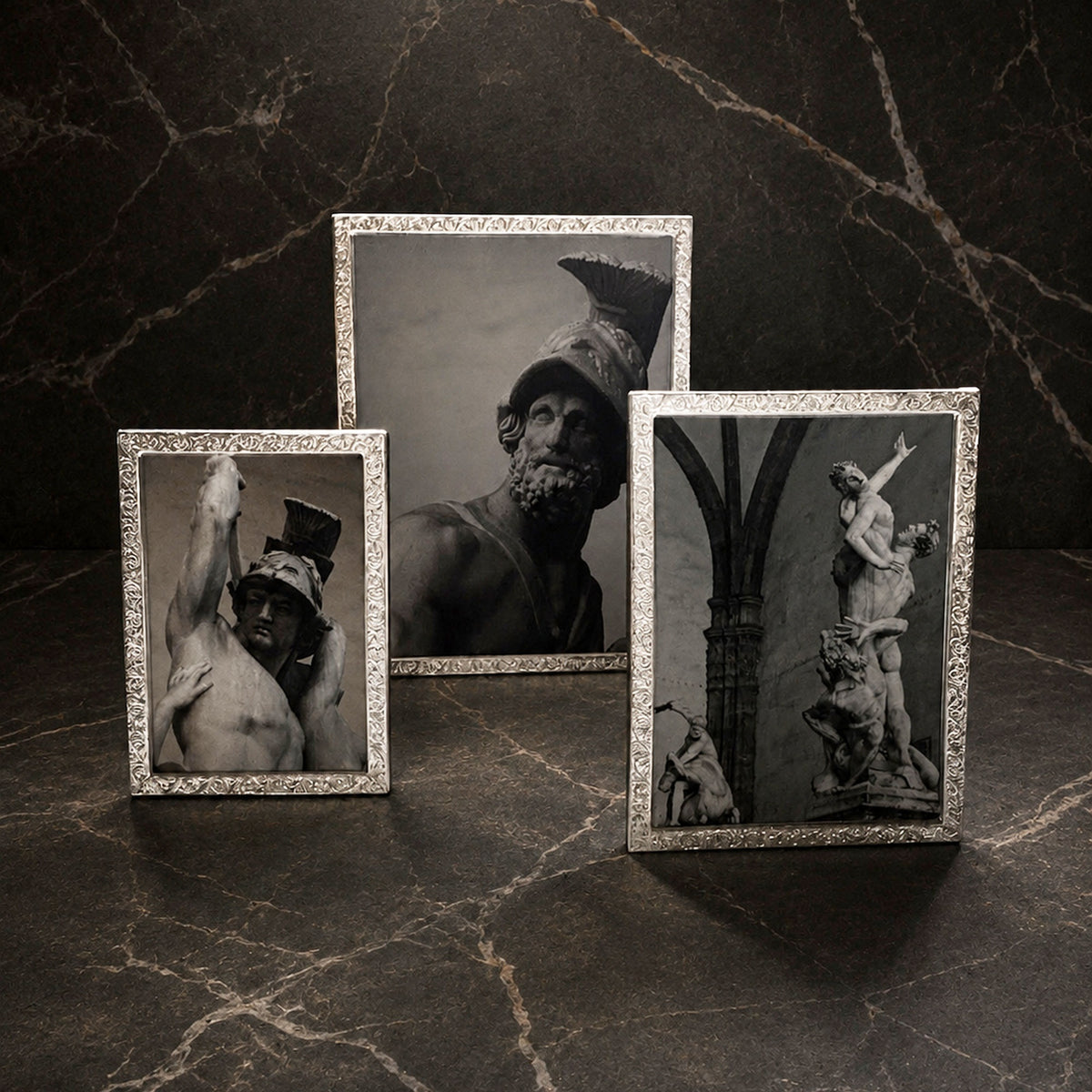 3 Sterling Florentine Frames on a black marble backdrop with black-and-white portrait prints.
