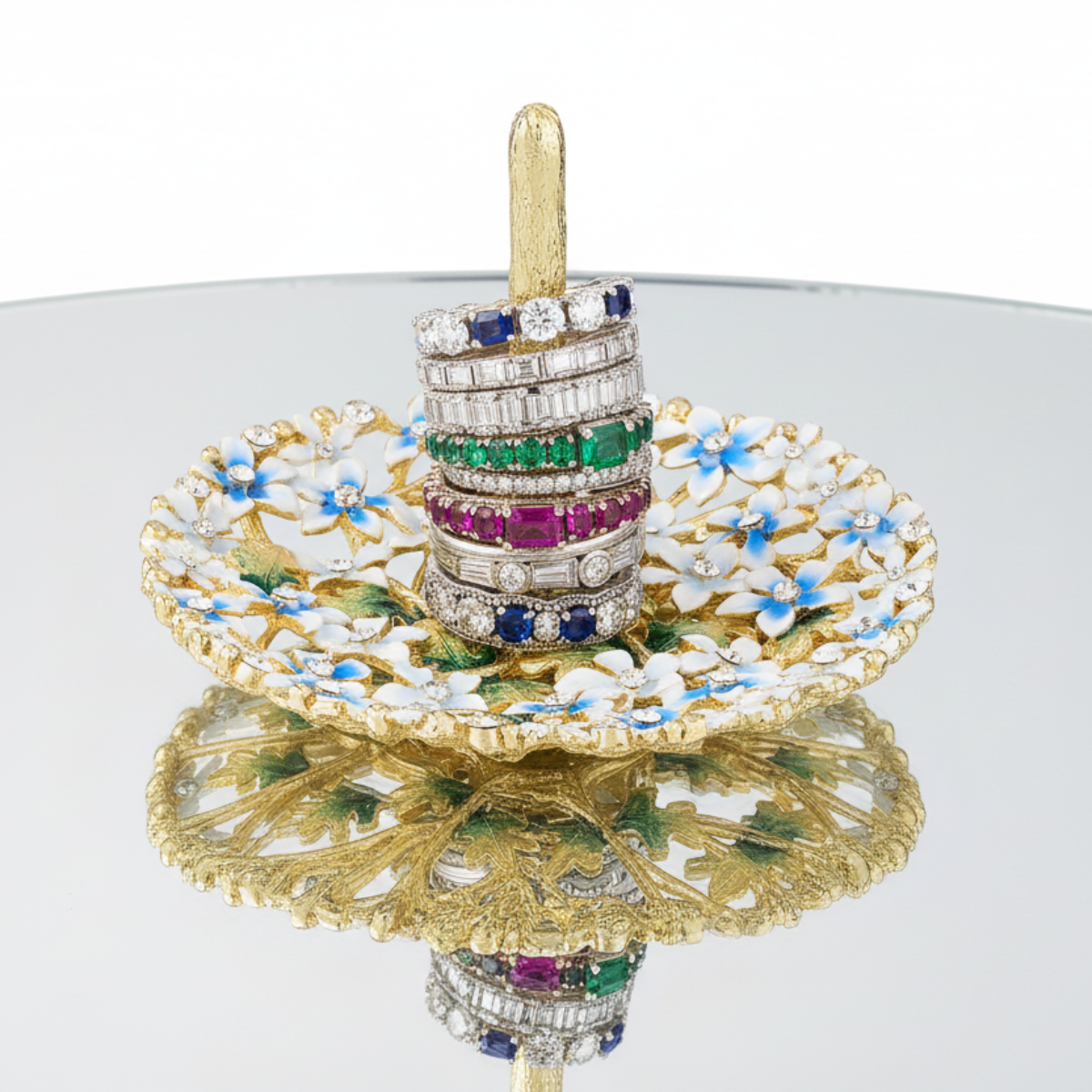 Daphne Ring Holder on a mirrored table holding a stack of opulent rings.