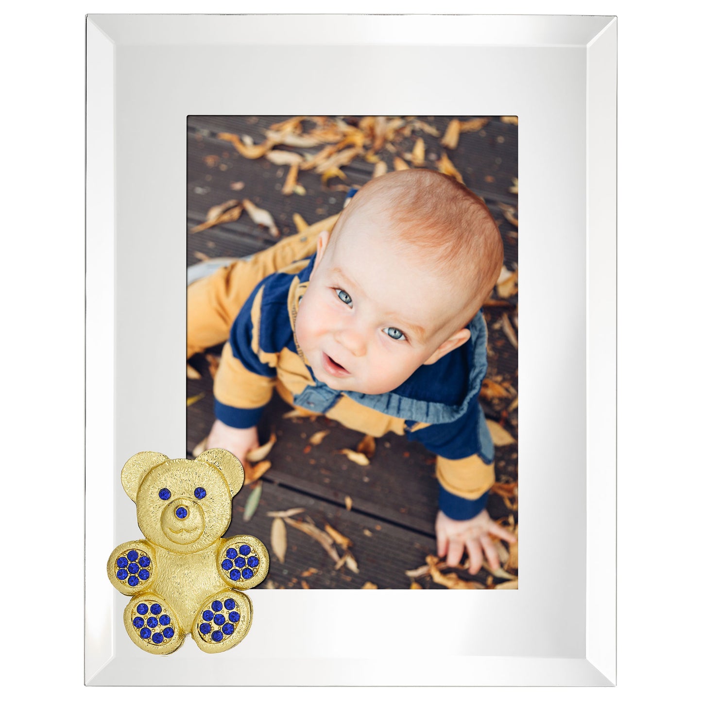 Beveled mirror picture frame with a teddy bear decoration with blue stones, displaying a photo of a baby outdoors.
