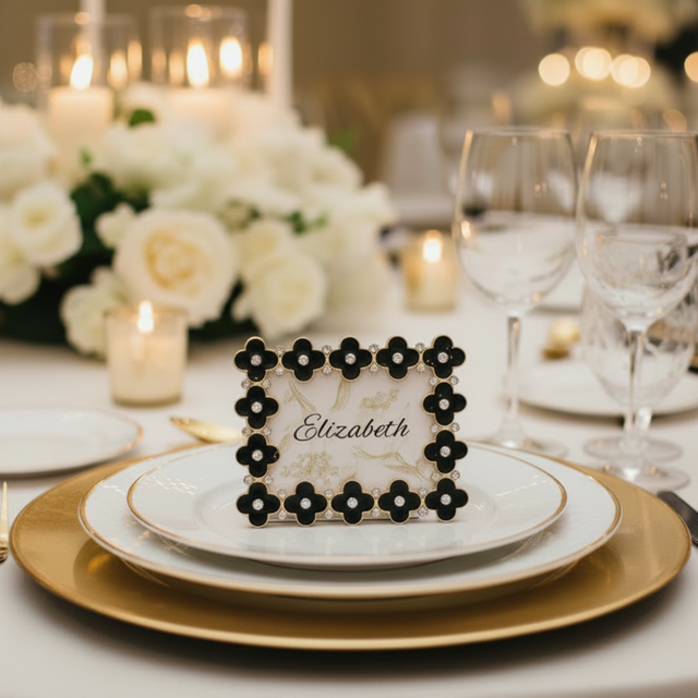 Black Enamel Clover 2.5 x 3.5 Frame as place card holder on gold and white place setting.