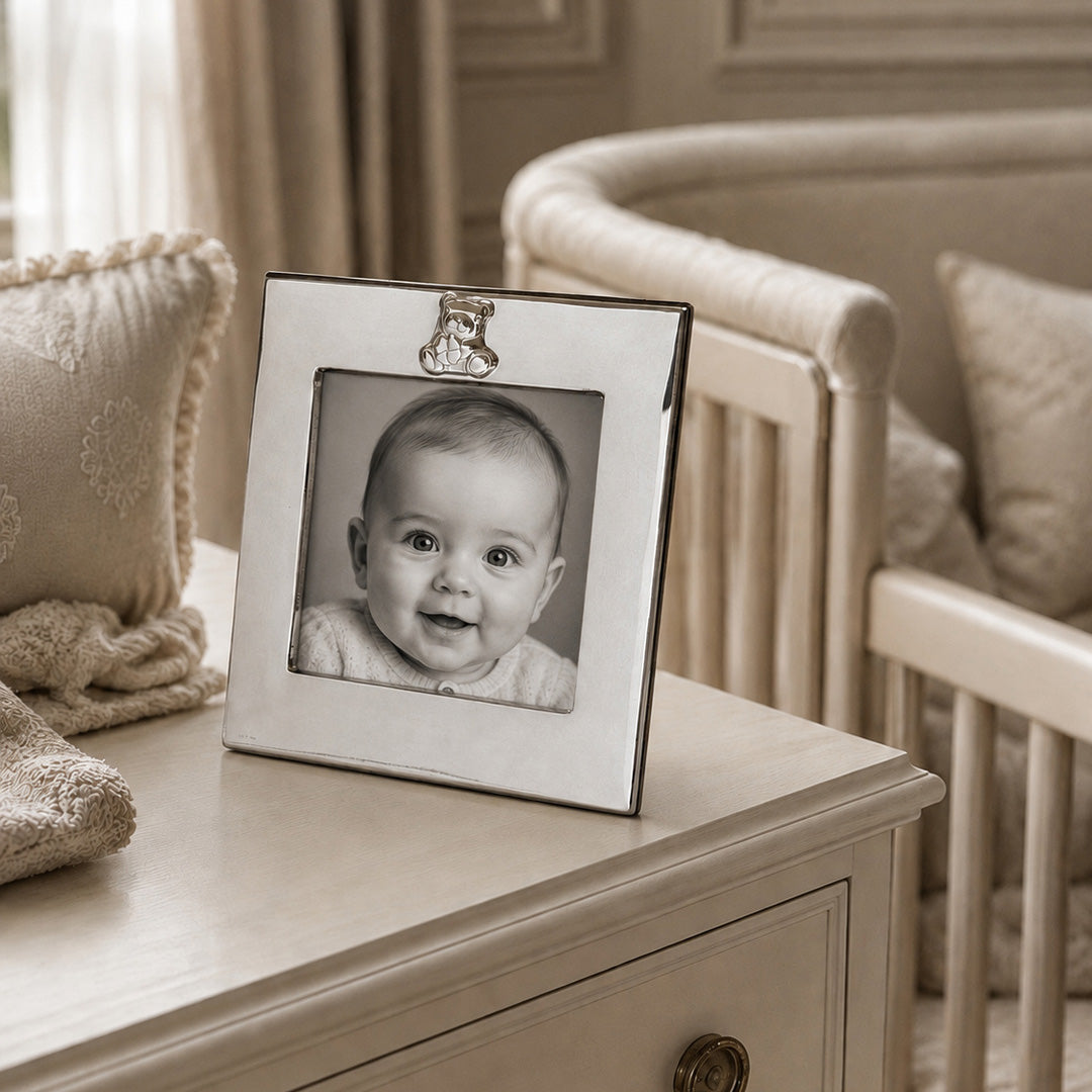 Sterling Cub Frame holding a black-and-white photo of a baby, styled on a light wooden dresser in a nursery setting.