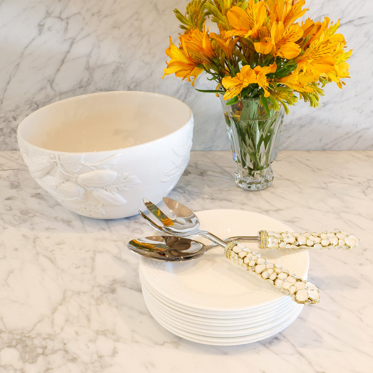 Dogwood Salad Serving Set on a stack of plates next to a salad bowl.