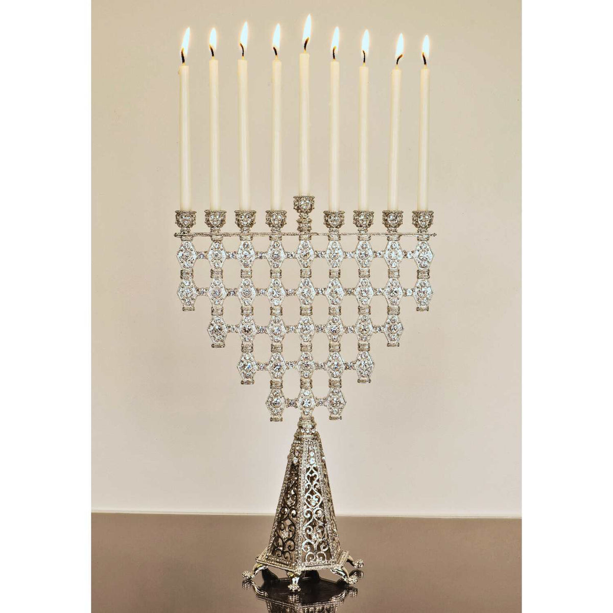 Silver Ziva Menorah with lit white candles.