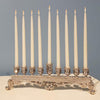 Silver bejeweled menorah with white lit candles