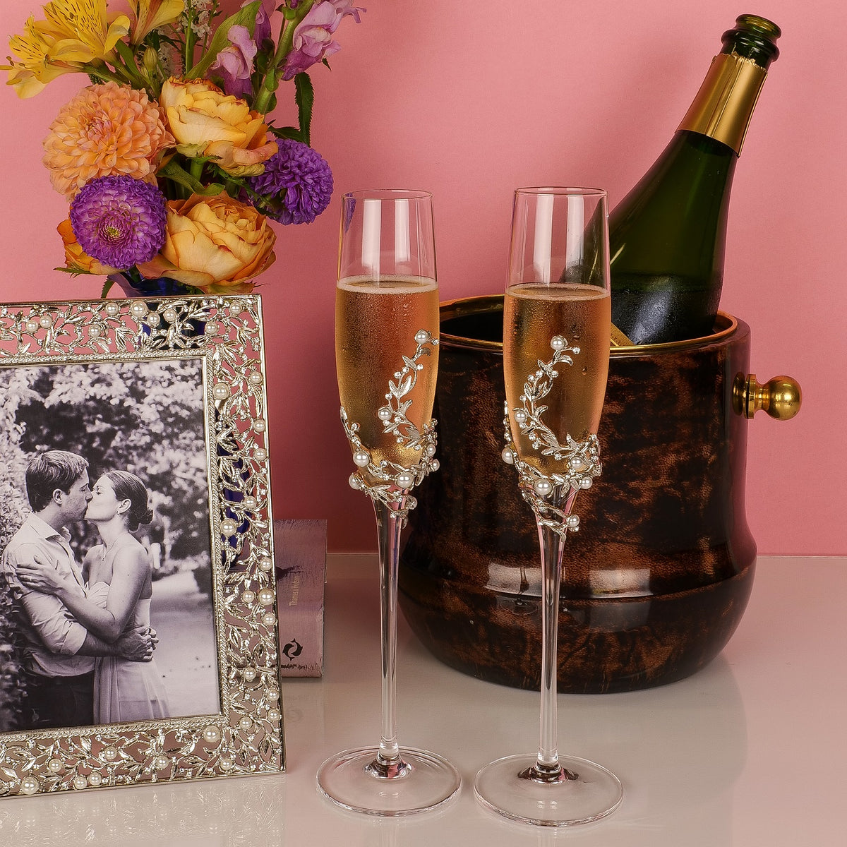 Silver Eleanor Flutes and matching Eleanor Frame in front of chanpagne bucket.